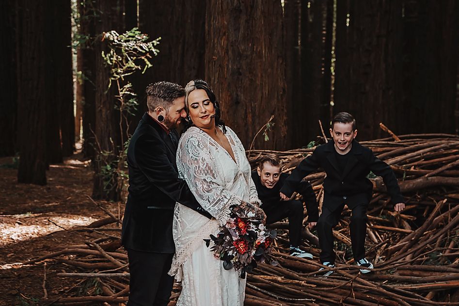 Wedding ceremony captured in sequence showing moments between the couple in a dramatic forest setting.