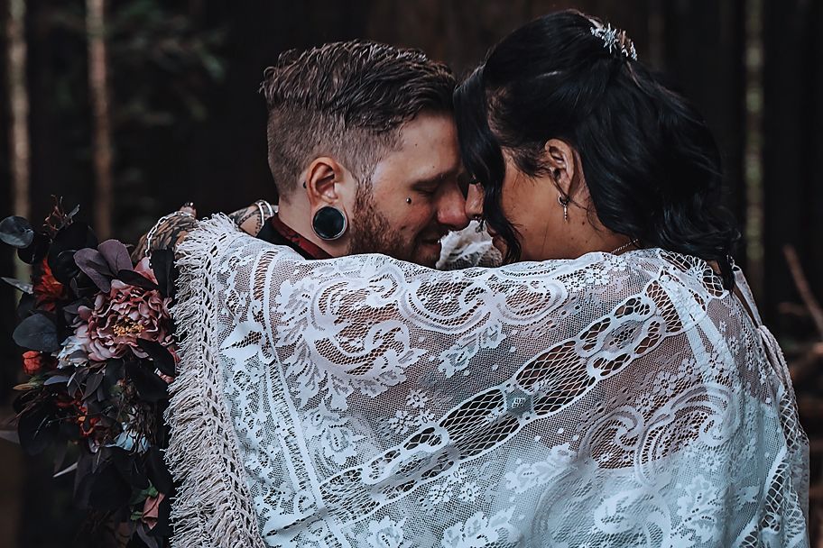 Couple dancing in an intimate pose on a dance floor with soft lighting and elegant attire.