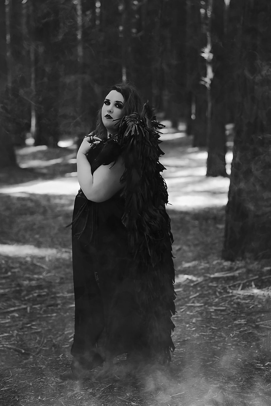 Dark atmospheric photos showing shadowy figure in black attire moving through misty forest setting.