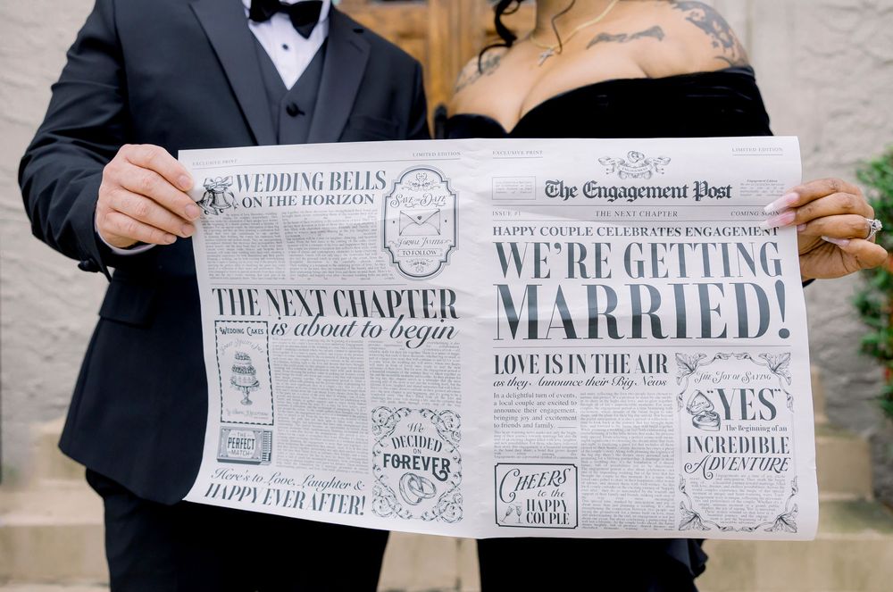 Couple holds custom newspaper-style wedding announcement with vintage inspired design.