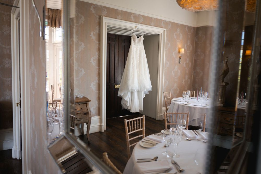 Elegant wedding venue interior with white decor, chandelier lighting, and romantic ambiance.