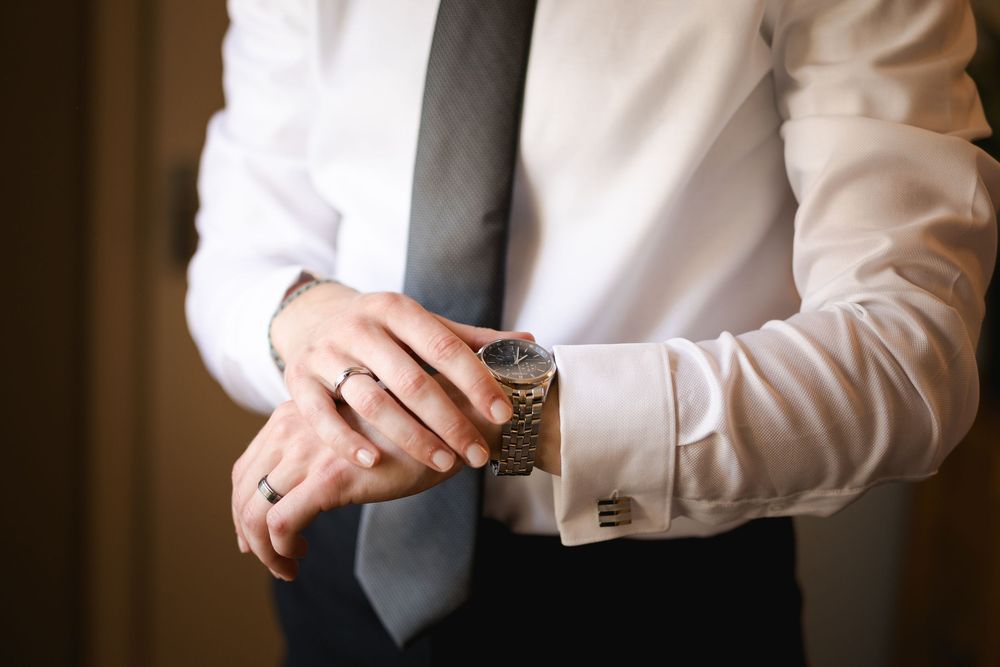 Wedding preparations showing cufflinks and formal attire details.