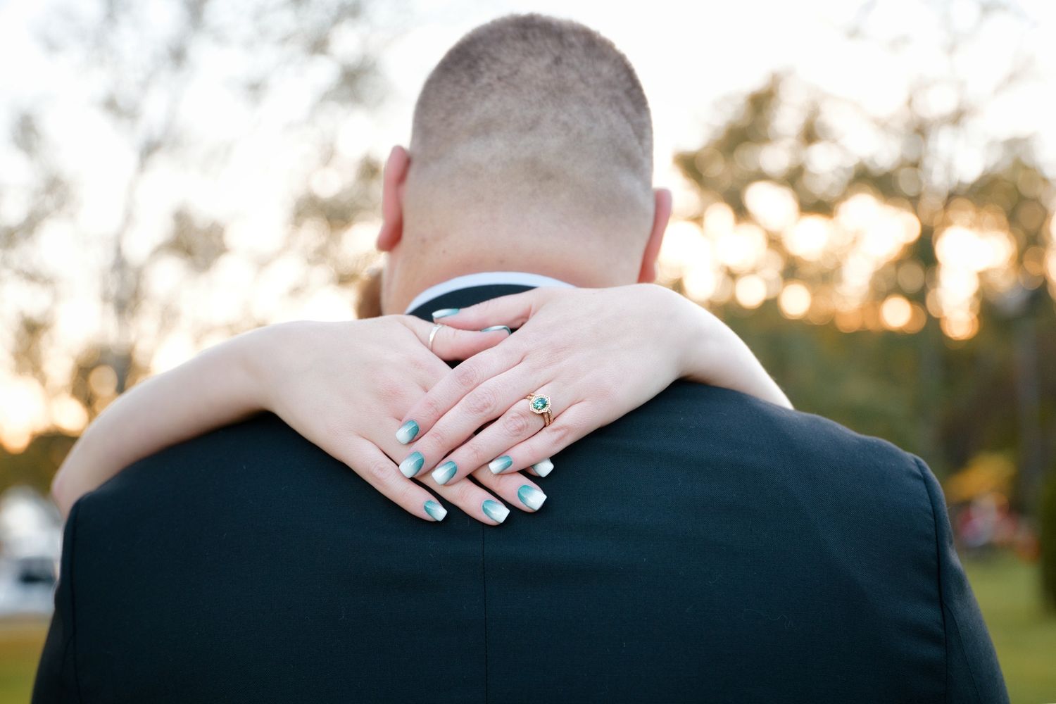 Close-up shot of hands resting on formal wedding attire during a romantic moment.