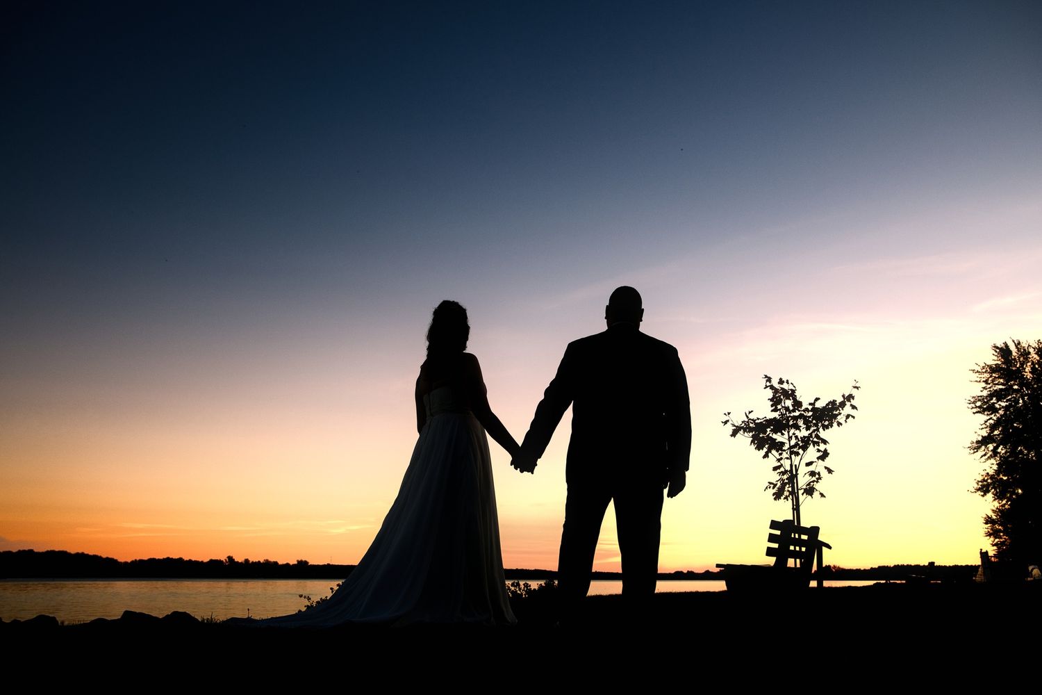 A series of silhouetted figures against colorful sunset skies with dramatic orange and purple gradients in the background.
