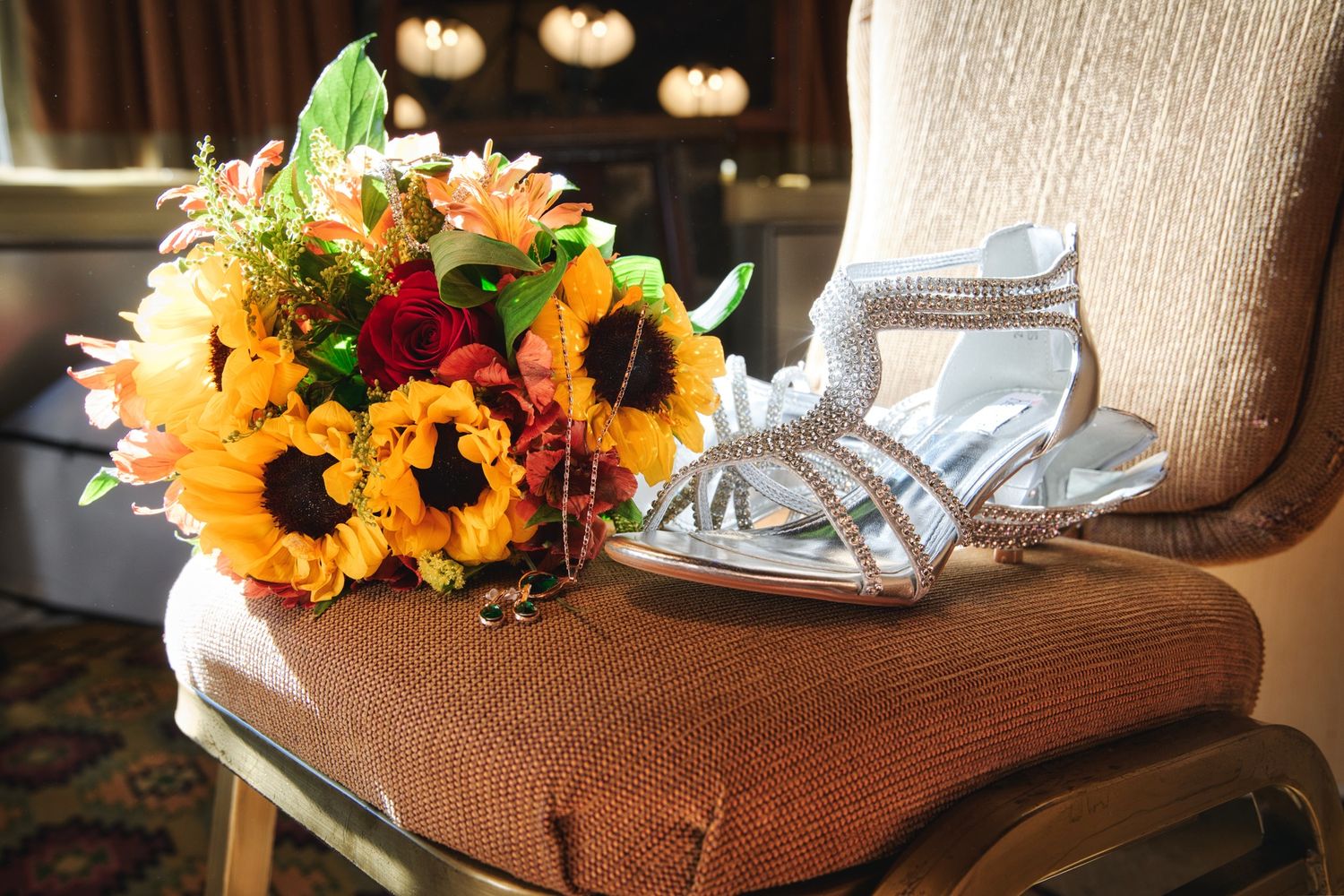 Vibrant autumn floral arrangements with sunflowers displayed on wooden surfaces in warm lighting.