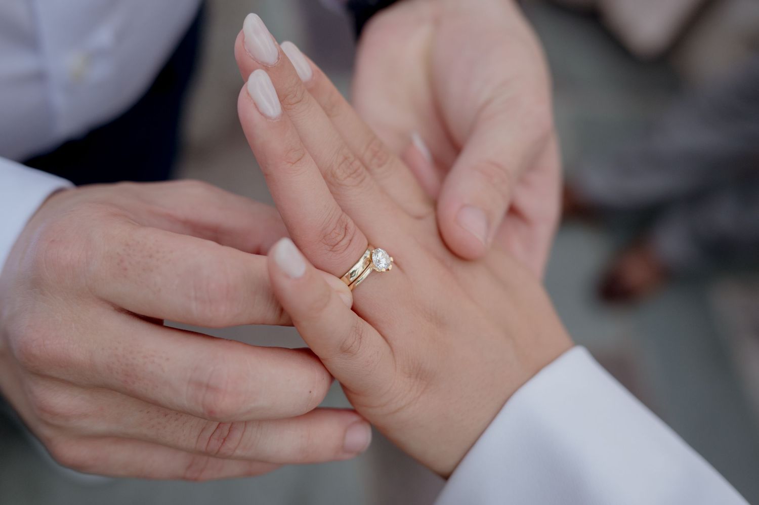 A close-up sequence shows hands exchanging a gold engagement ring, capturing the moment of a marriage proposal.