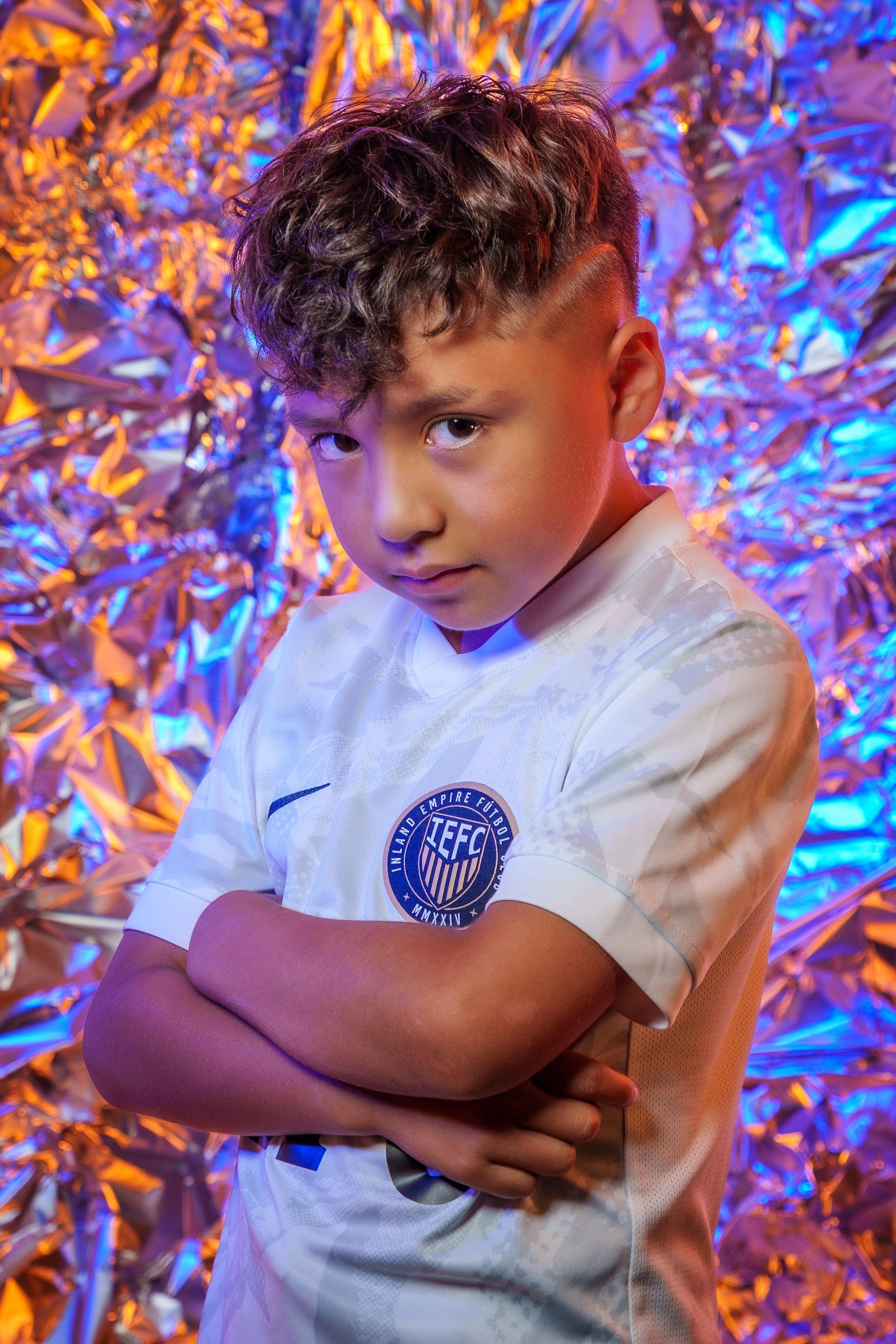 Athletic apparel photo featuring a white jersey against colorful orange and blue backdrop.