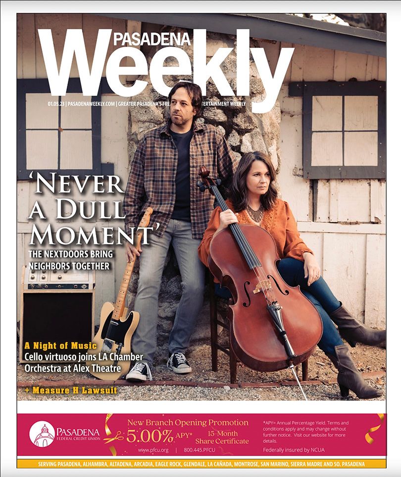 Magazine cover featuring The Nextdoors with guitar and cello outside weathered building. Shot by Mika Larson Photography.