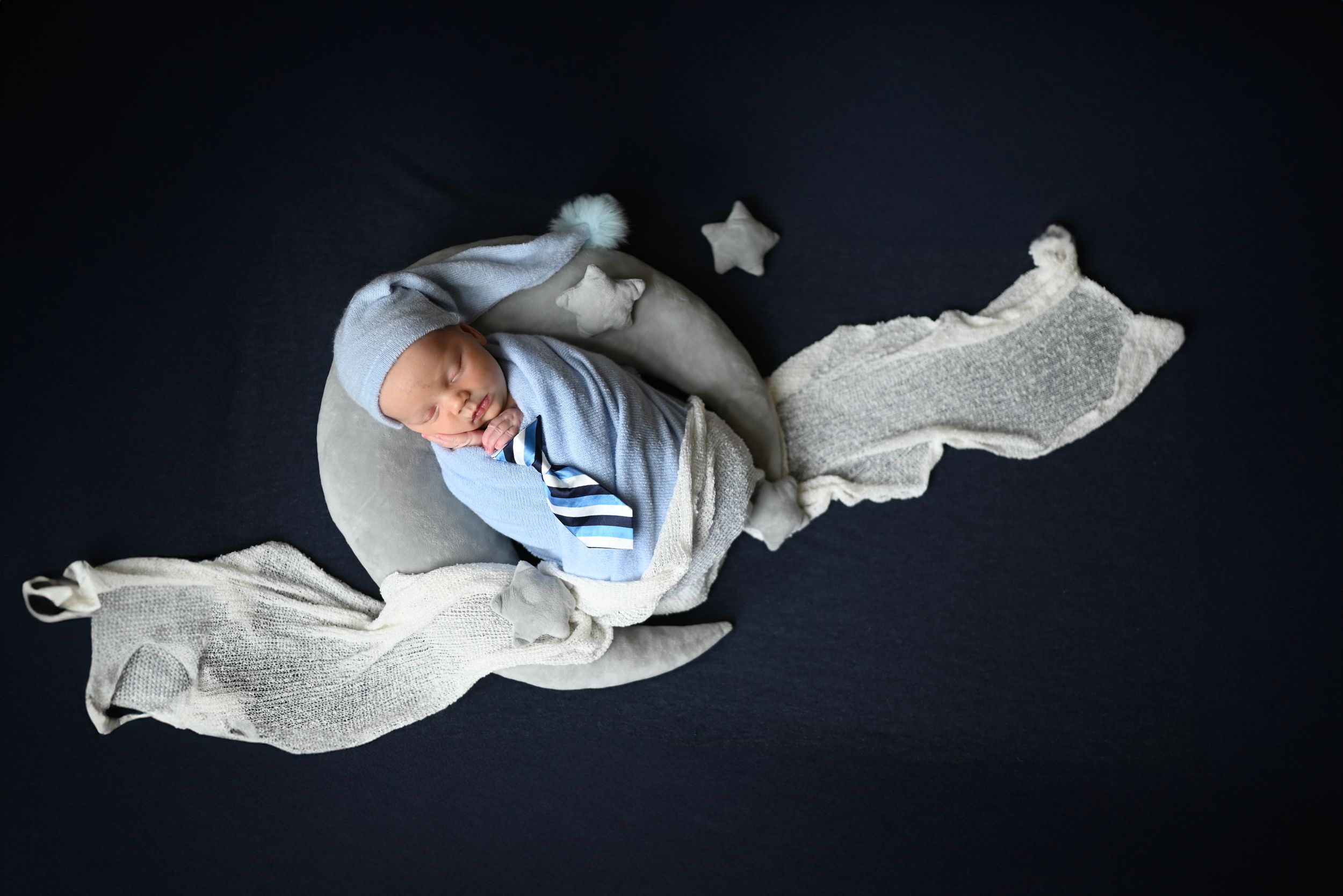 Series of dark photographs showing white ballet slippers on a black background with varying angles and positions.
