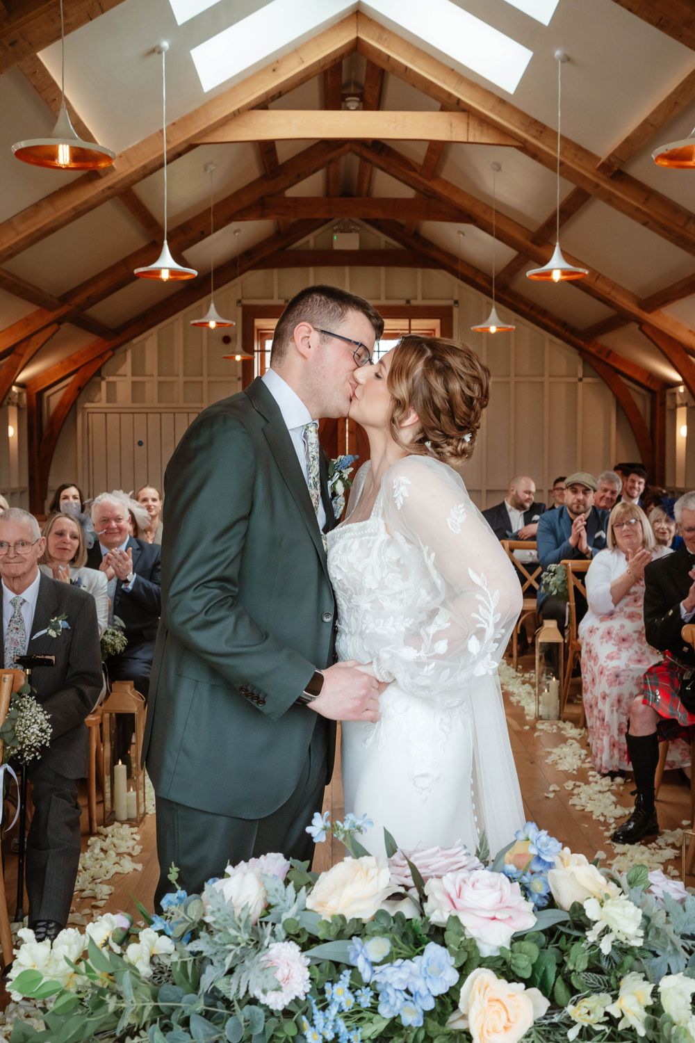 Hyde House Wedding Photographer Cotswolds Zara Davis Photography Gloucestershire Cheltenham bride groom first kiss barn spring flowers