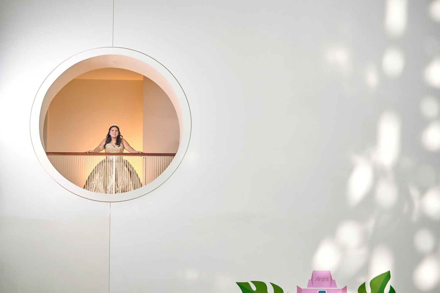 Wedding photography composition with bride framed in circular window.