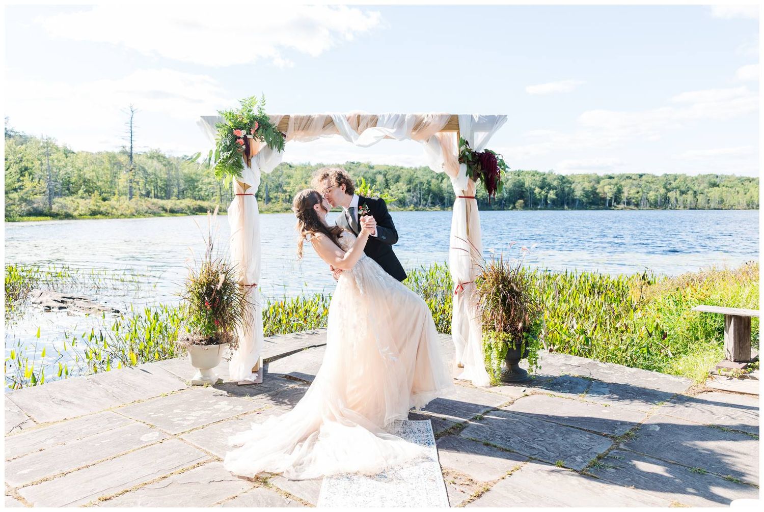 Scenic lakeside wedding ceremony with mountain views and natural landscaping.