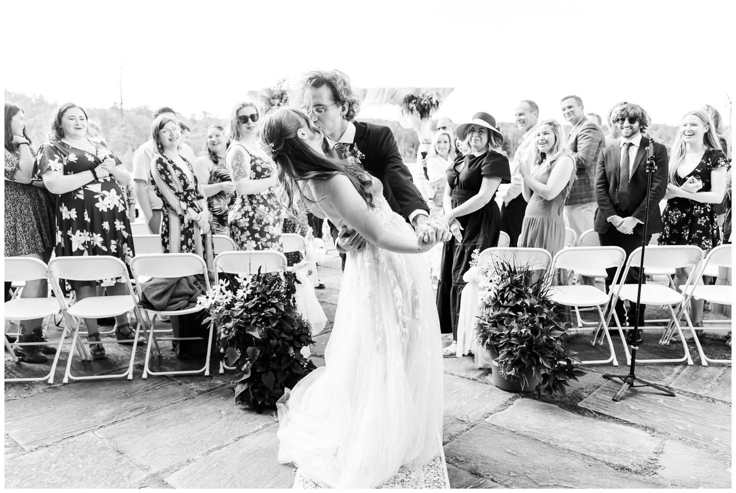 Black and white wedding photos capturing candid ceremony moments by the waterfront.