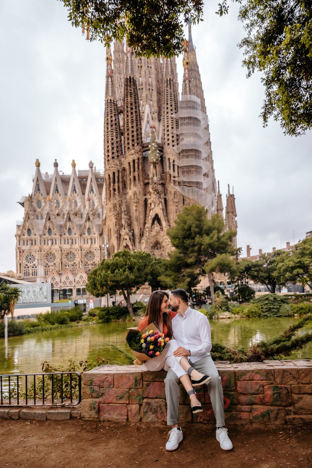 Couple walking joyfully through blooming flowers.