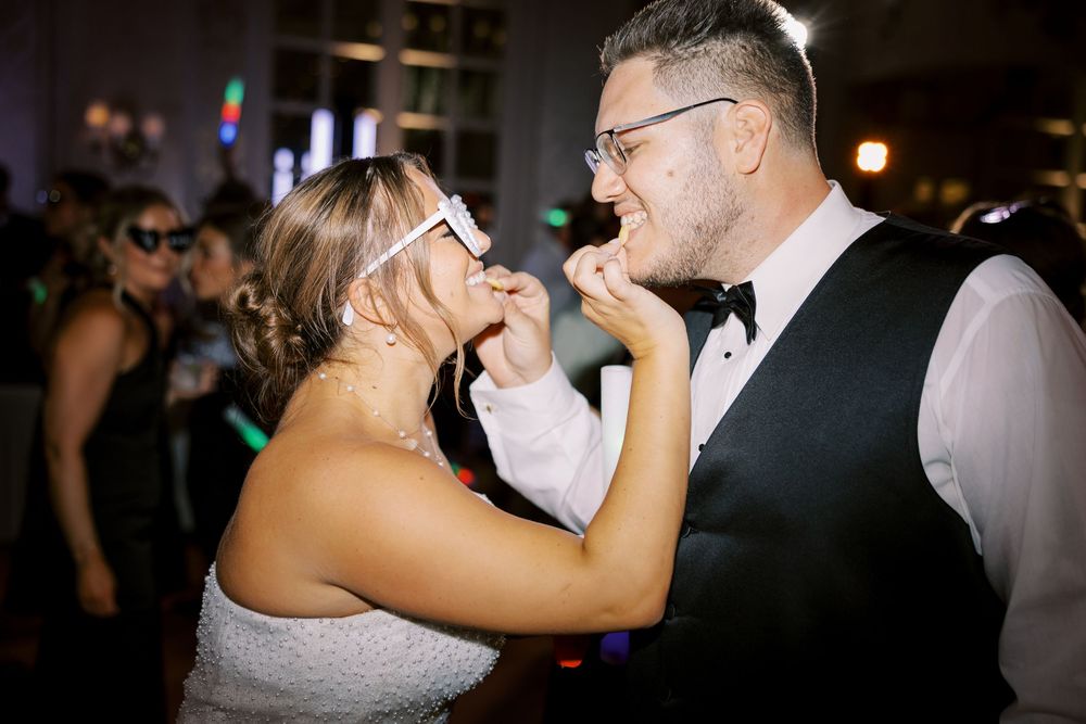 Couples dancing together at a joyful wedding reception celebration in an elegant venue.