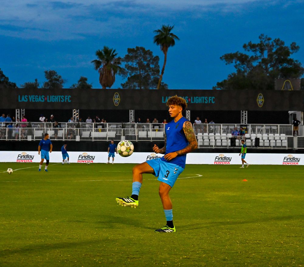 Las Vegas Lights FC player number 3 practices ball control during pre-game warmup at Cashman Field.