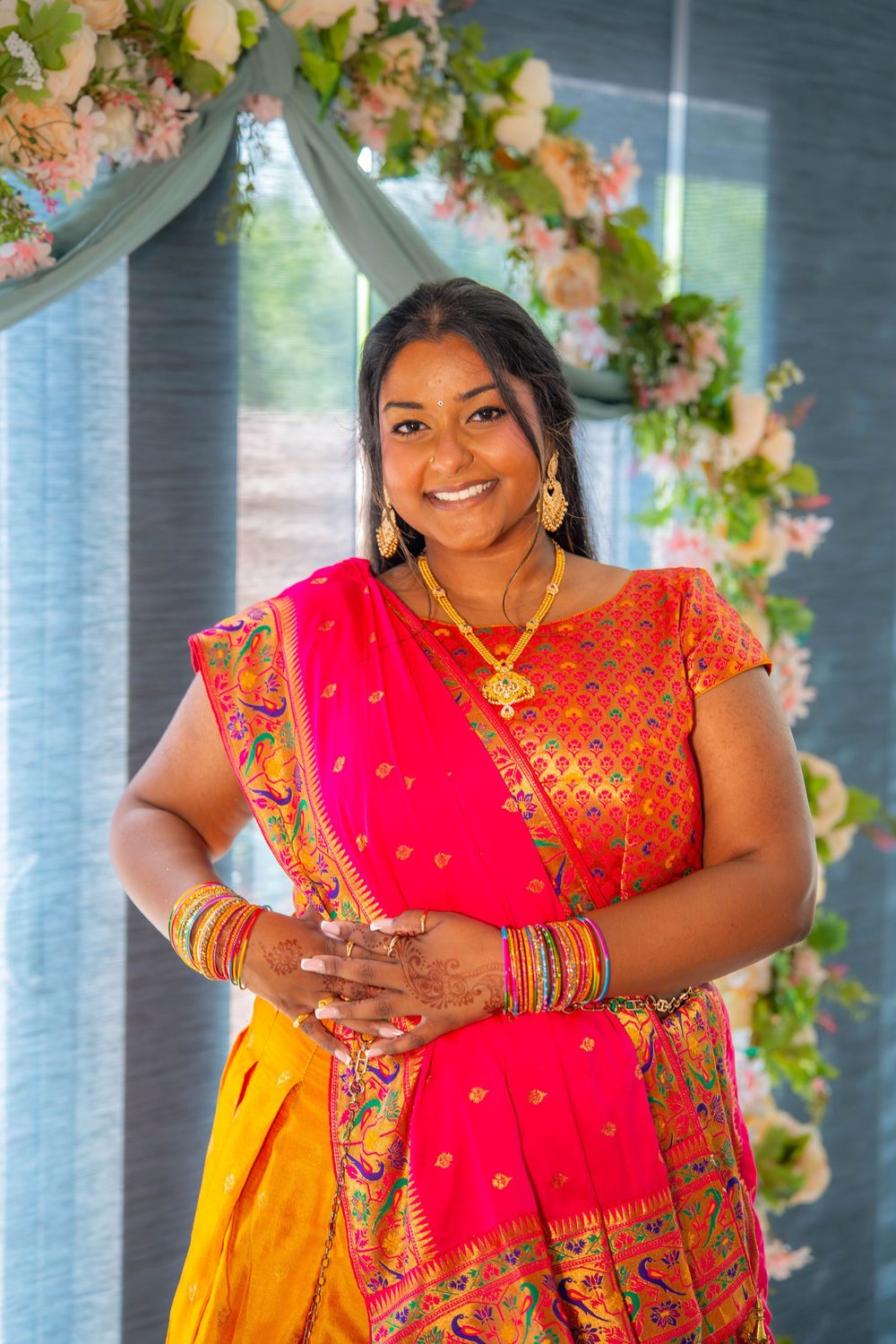 Beautiful traditional South Asian attire featuring vibrant red and gold sari. Nischitartham Quad Cities Hindi Indian Photographer