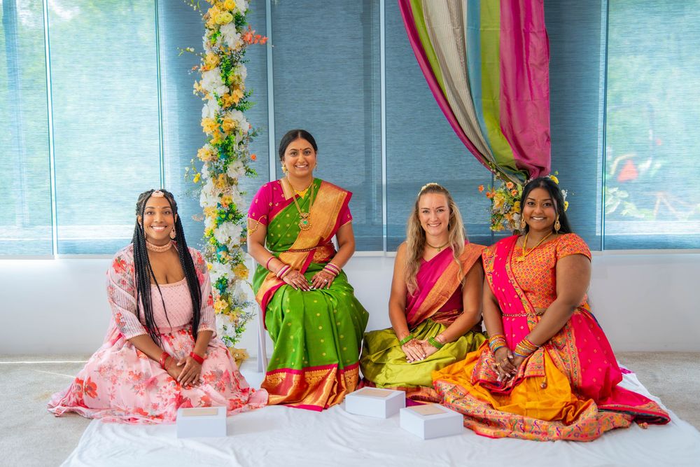 A group poses in colorful traditional Indian saris and dresses. Nischitartham Quad Cities Hindi Indian Photographer