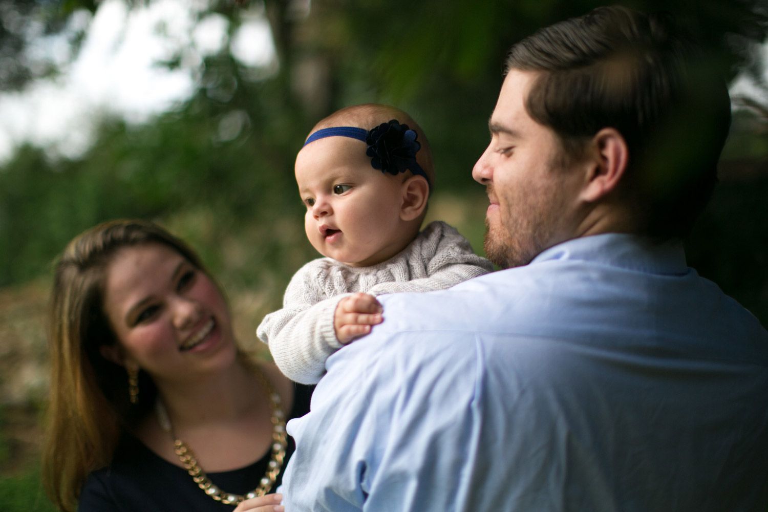 Intimate family portrait session outdoors with soft natural lighting.