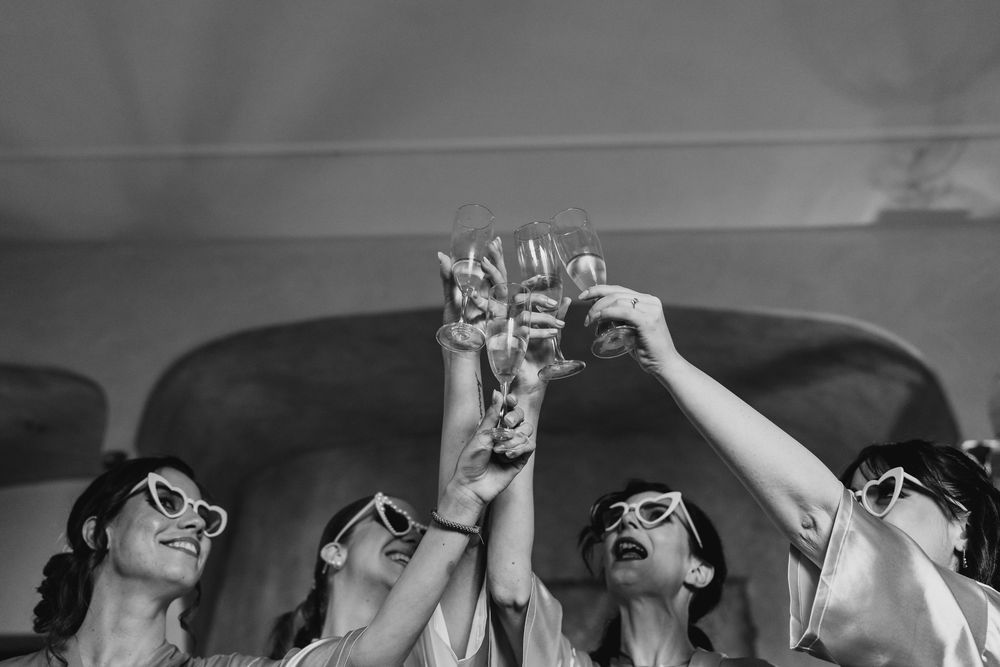 Wedding party wearing sunglasses and posing in black and white photography.