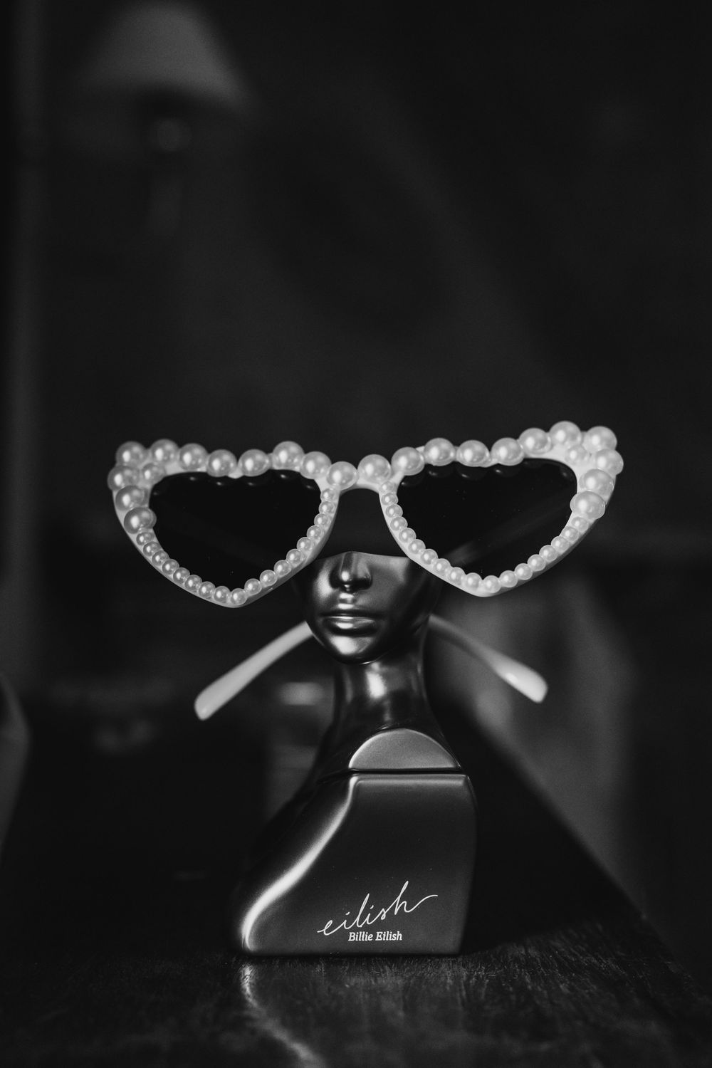 Black and white photo of decorative sunglasses with pearl details.