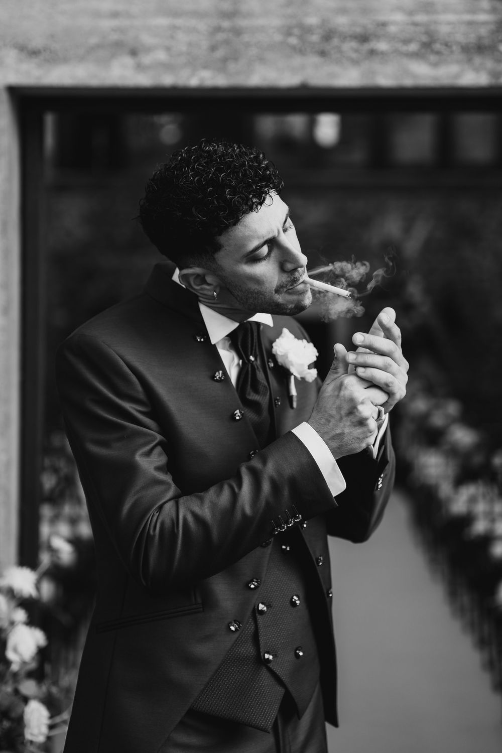 Black and white photo sequence of a groom adjusting his tie before the ceremony.
