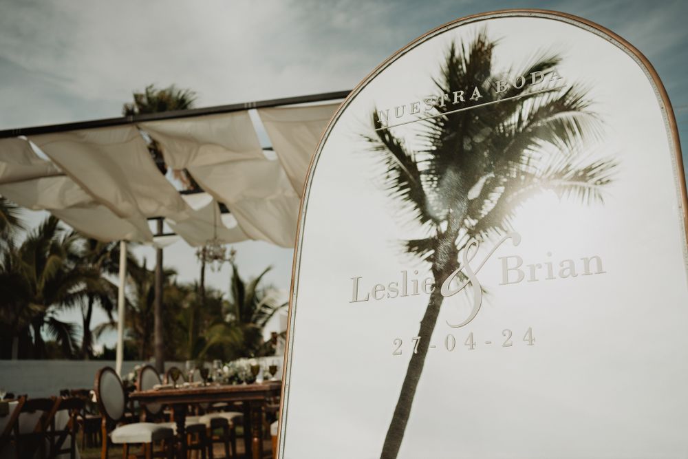 Personalized mirror reflecting a palm tree, adding a tropical touch