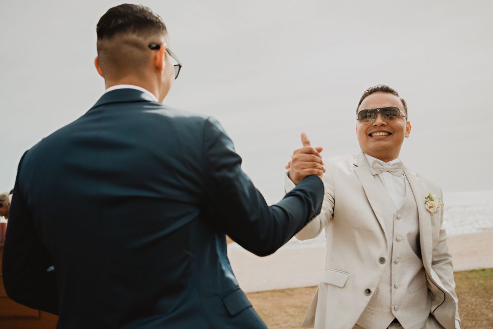 The groom greeting a friend, showing camaraderie