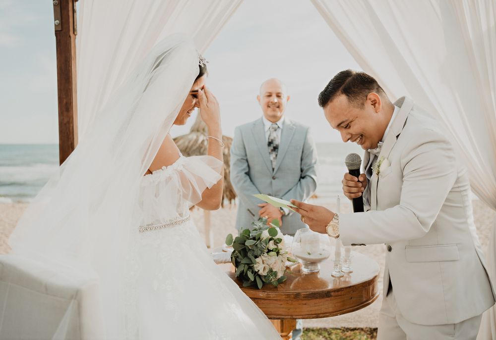 The bride laughing as the groom delivers his vows, a unique moment