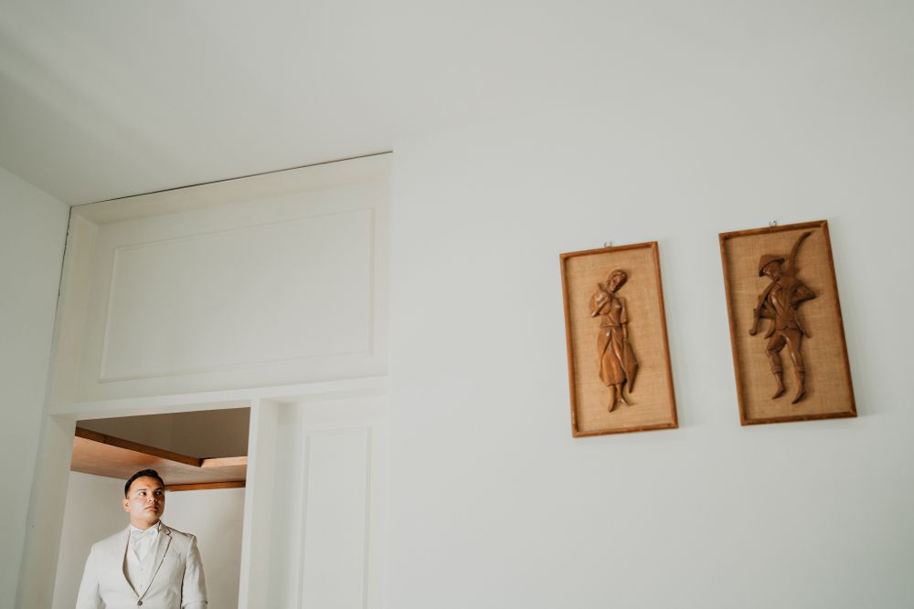 Artistic shot of the groom framed within geometric patterns