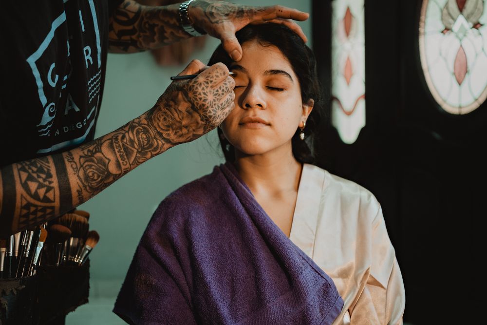 The bride getting her makeup done, radiating beauty
