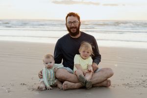 Family enjoying sunset beach time together on sandy shore.