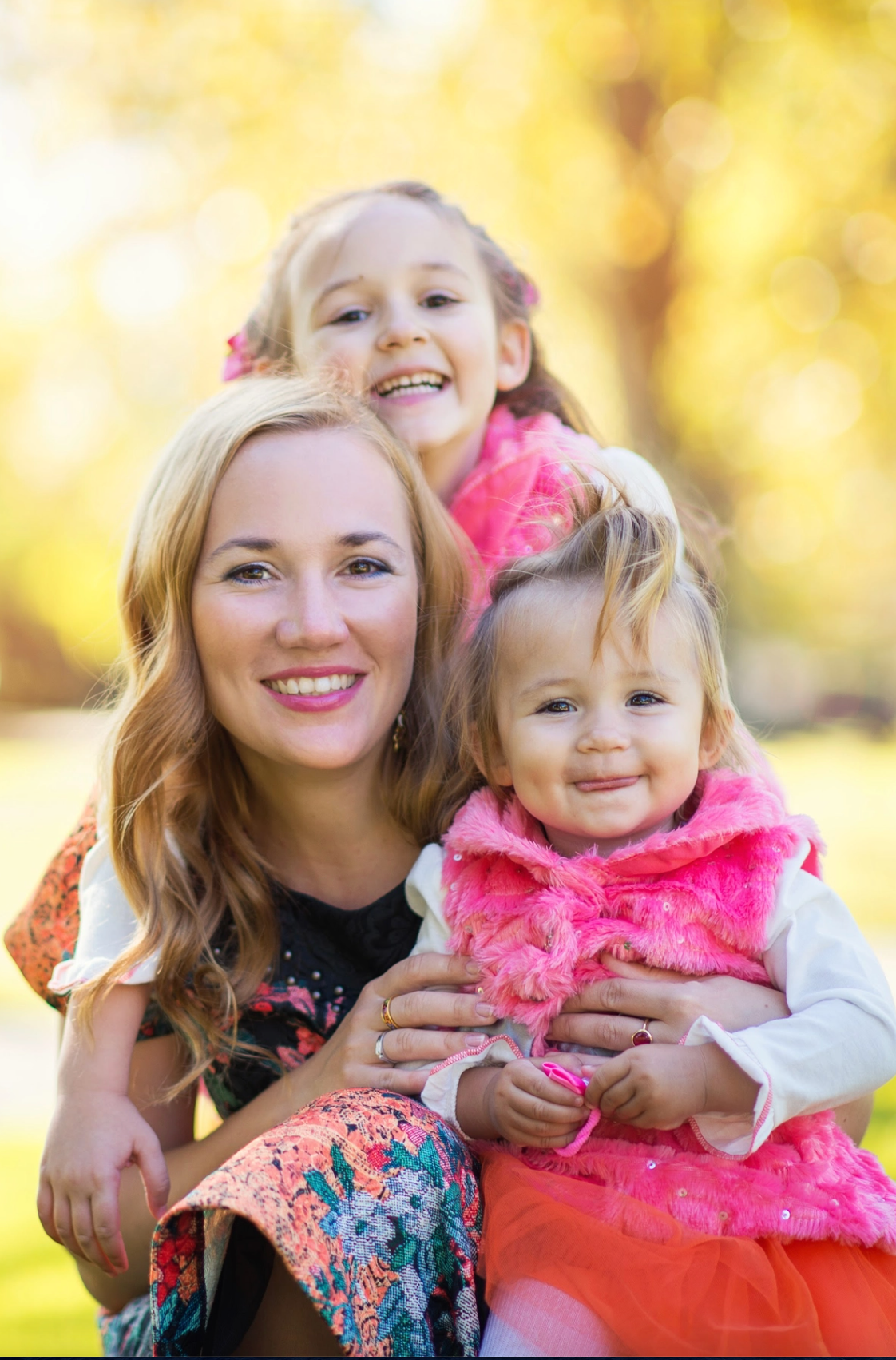 Bay Area family photography capturing young girl holding colorful flowers outdoors.