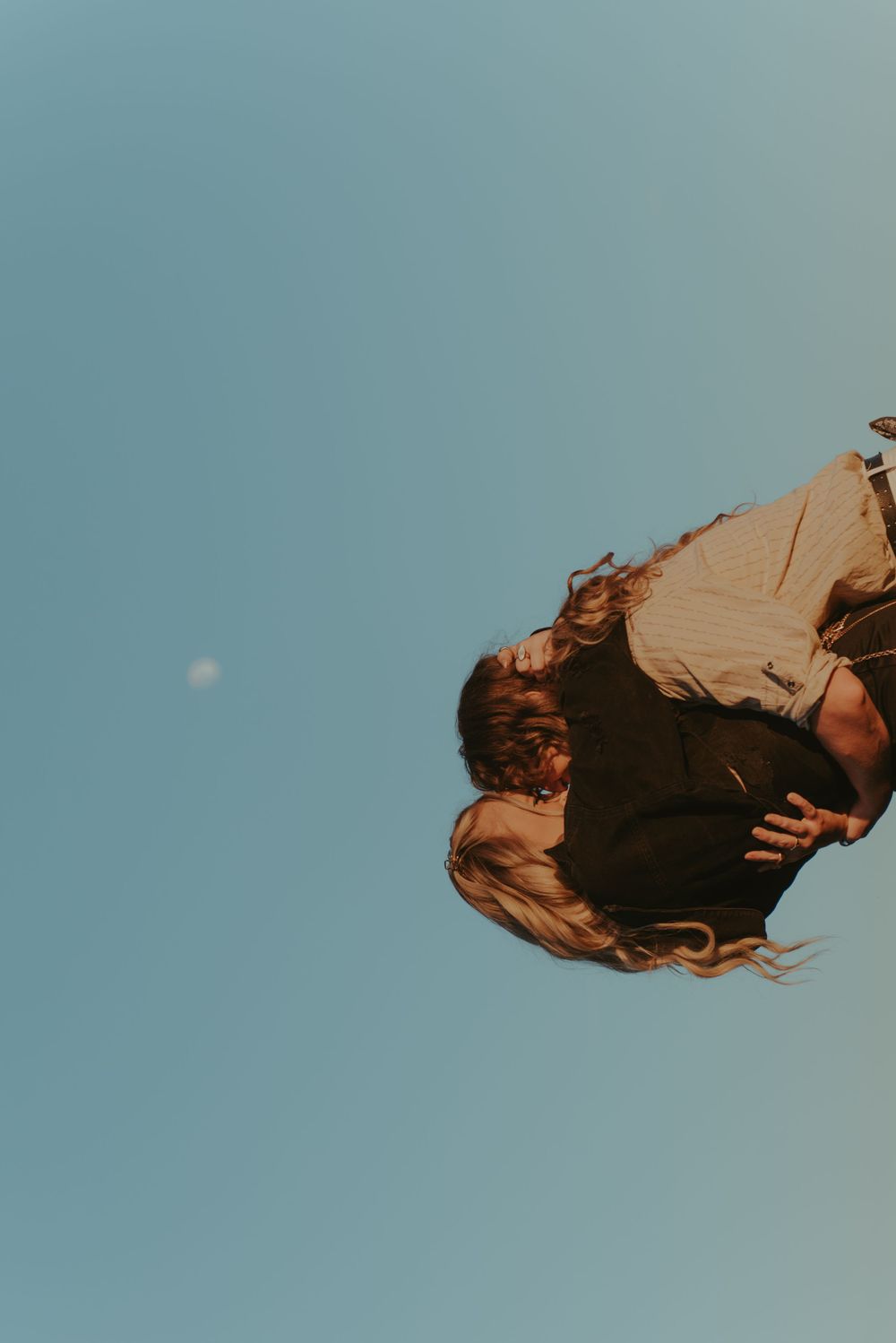 A portrait of a couple hugging each other.