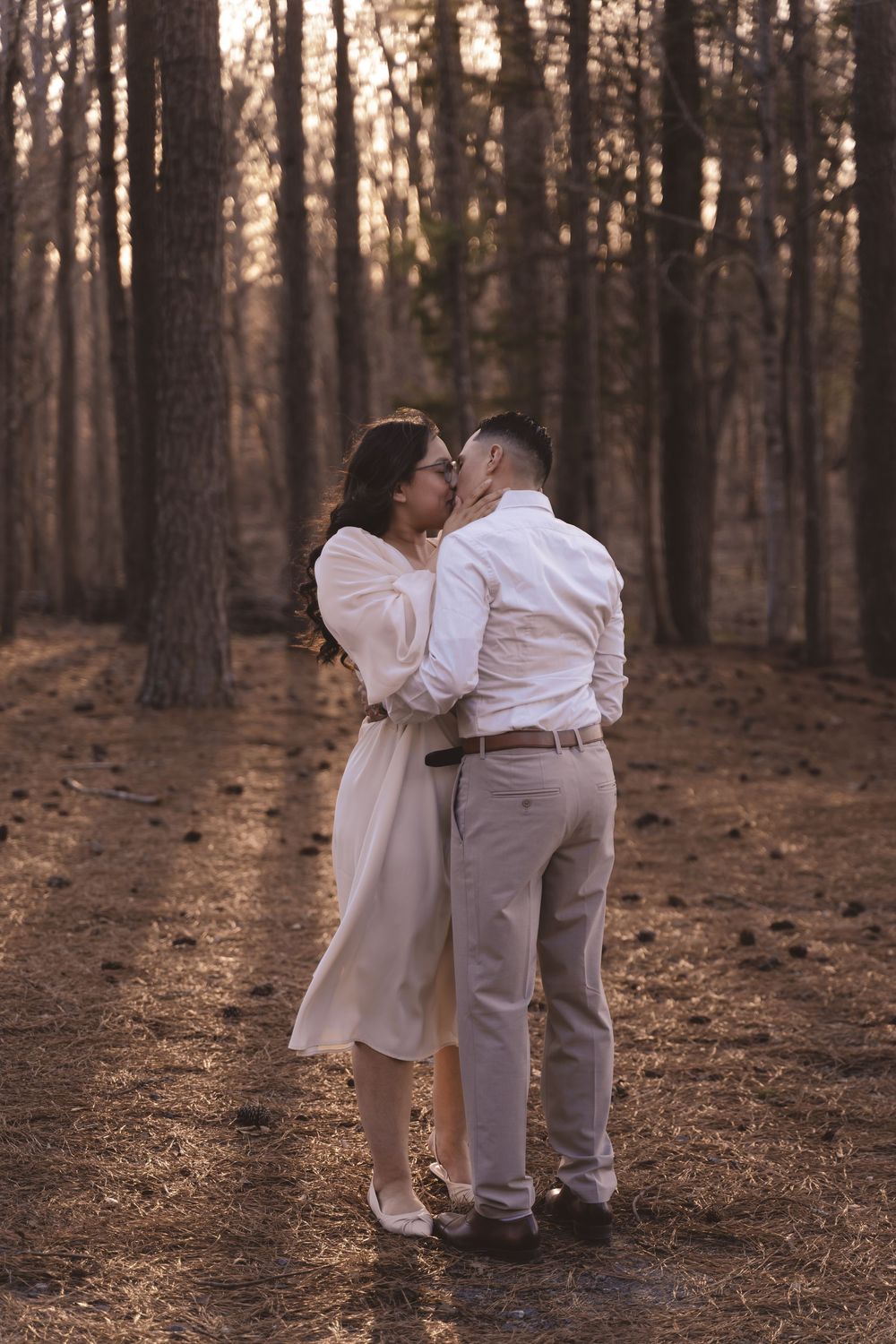 Engaged couple kissing in the woods at Anne Springs Greenway in Charlotte, North Carolina
