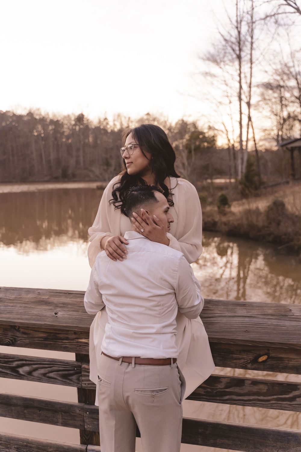Engaged couple closely looking onward at Anne Springs Greenway in Charlotte, North Carolina