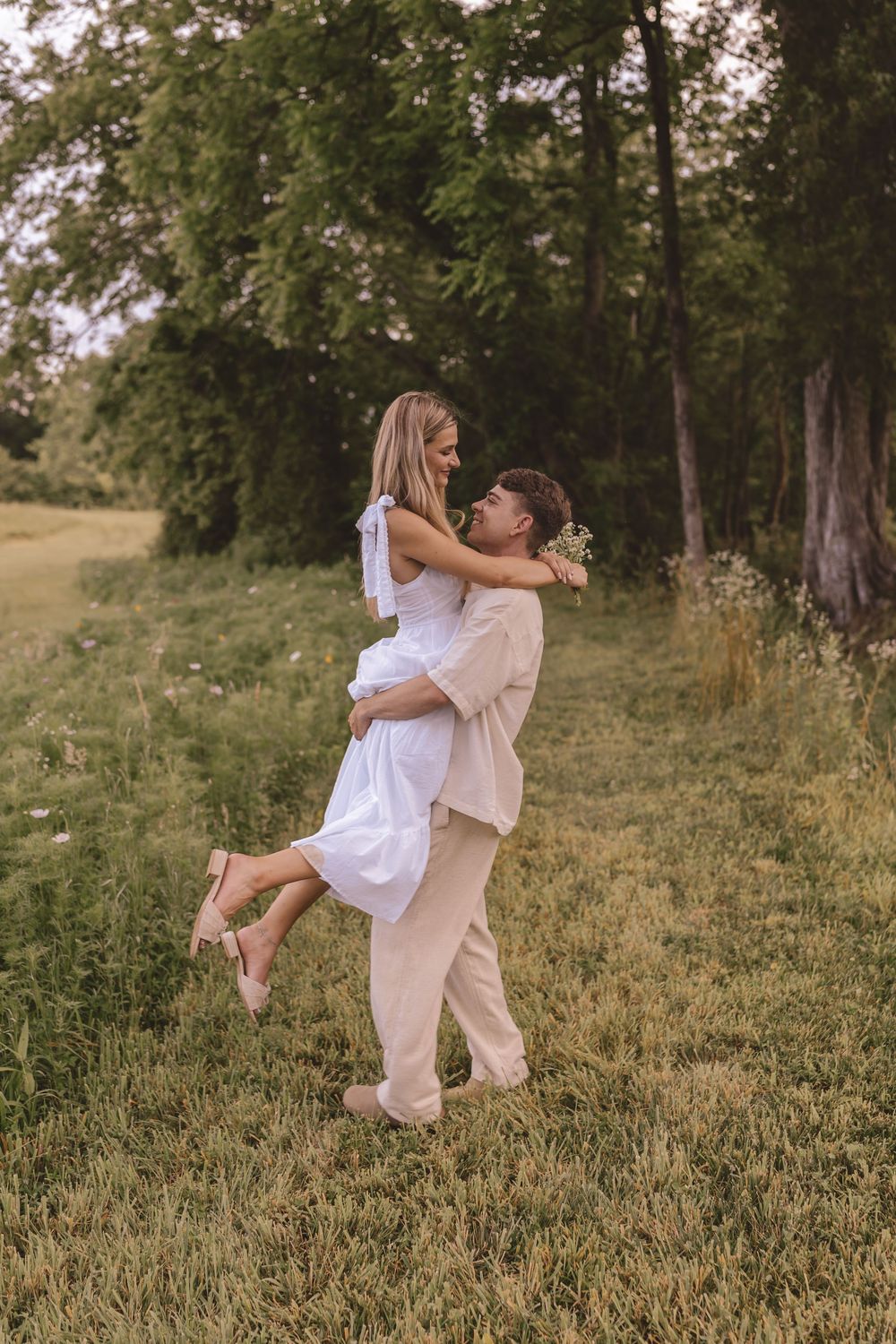 Engaged couple twirling in the garden at Willow and Stone Events in Mocksville, North Carolina