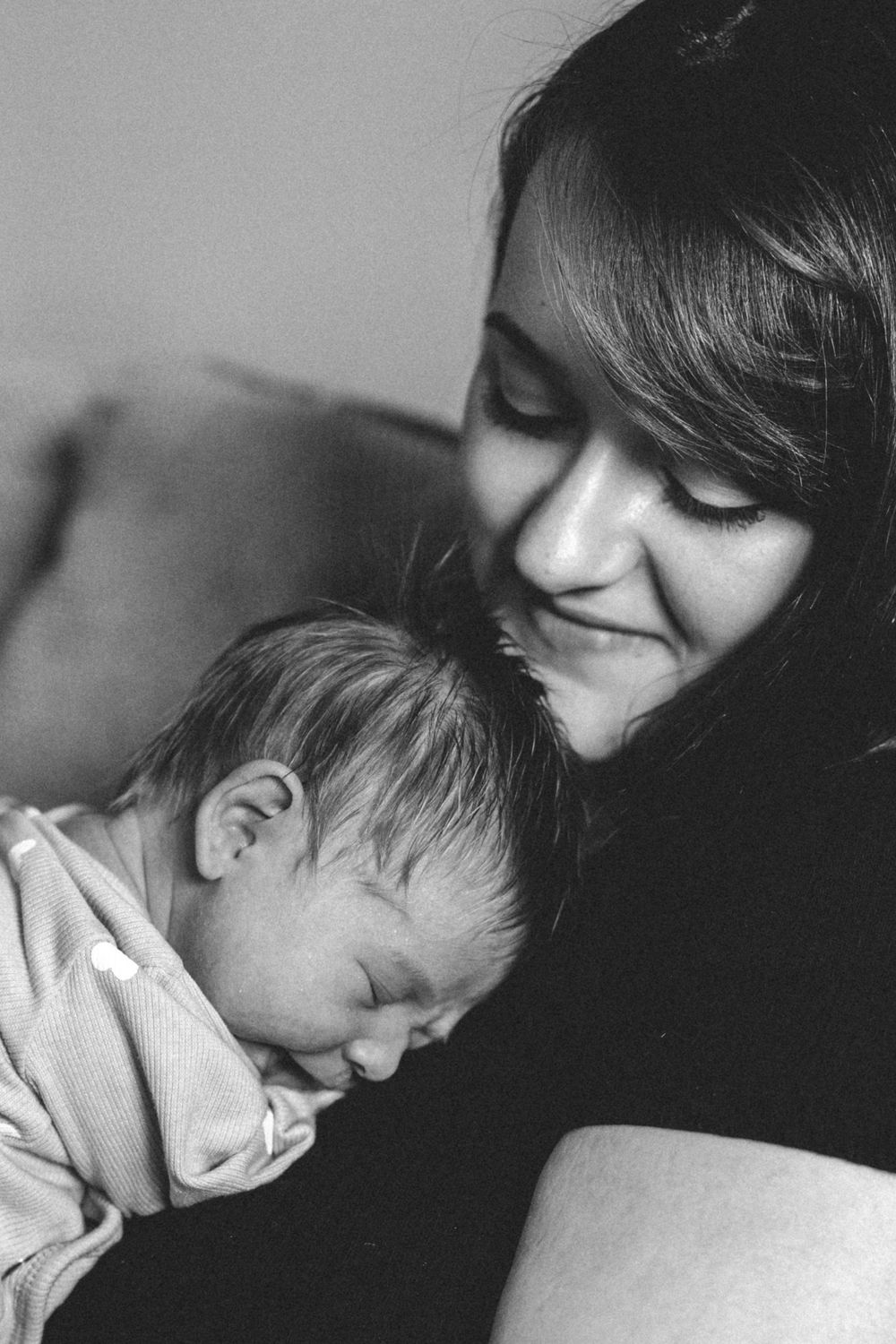 A tender black and white photo series showing intimate moments of connection and comfort between parent and child.