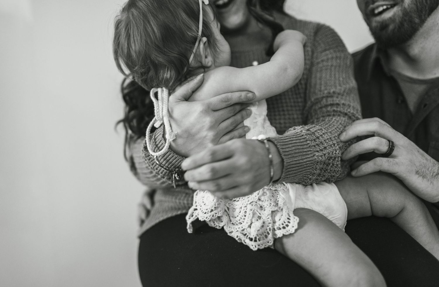 Close-up black and white photo of tender family embrace and connection.