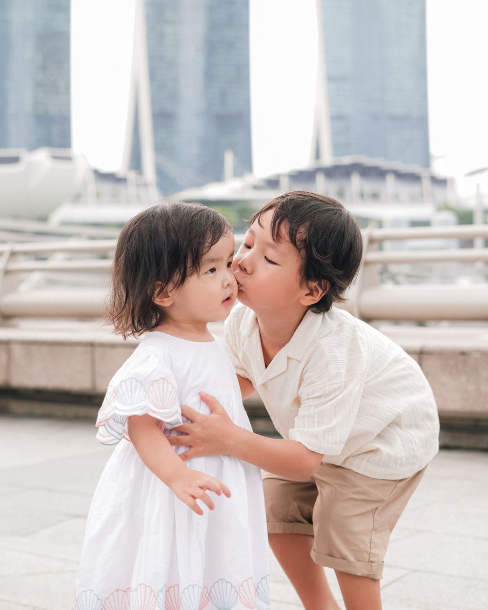 Sweet moment shared between parent and child near Singapore waterfront.