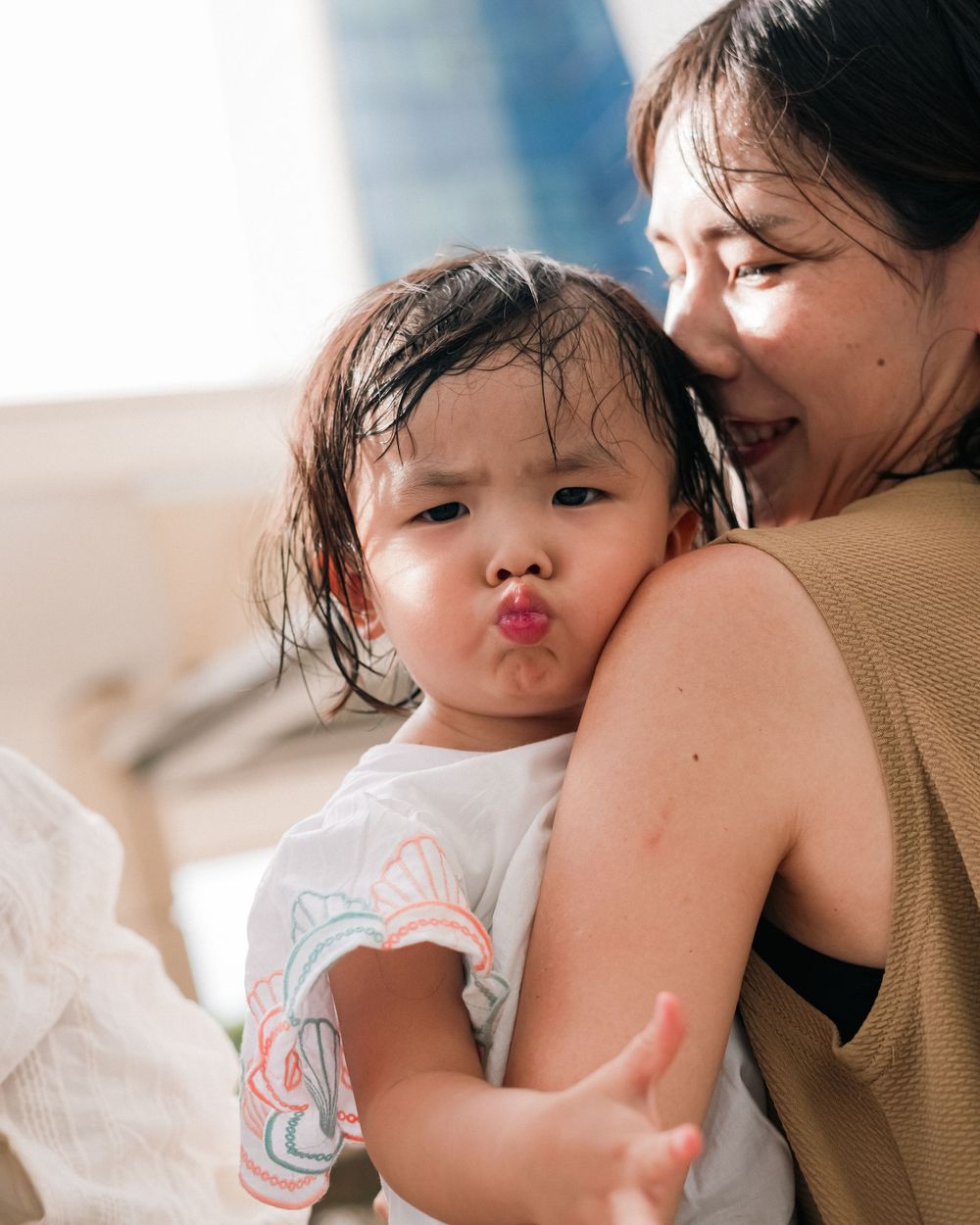 A sweet moment captured between a child and adult with playful expressions.