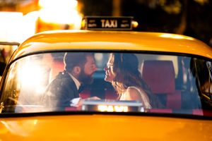 A warm, glowing moment inside a yellow taxi cab during sunset.