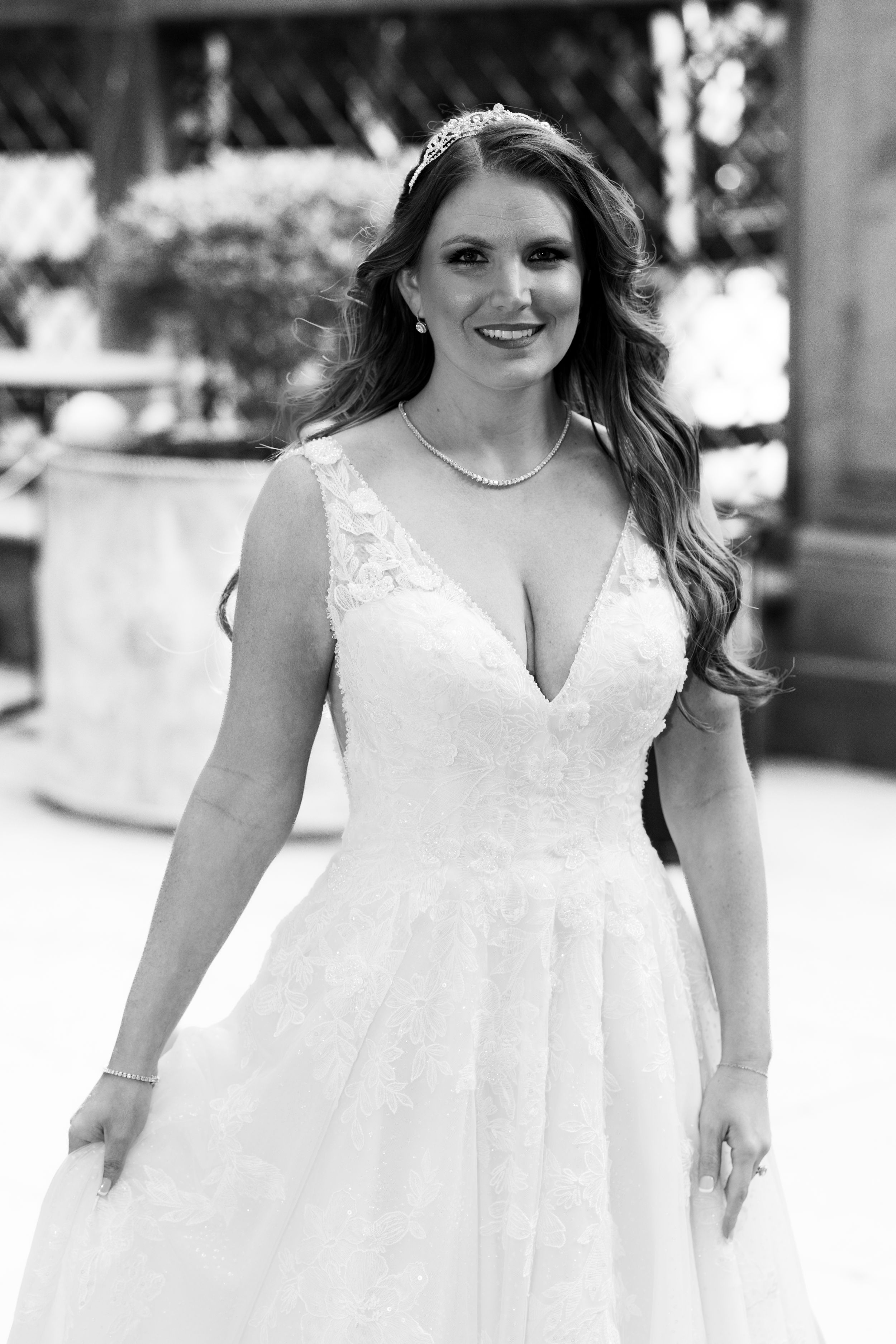 Black and white bridal portrait showcasing v-neck lace wedding dress.
