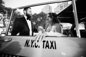 A vintage black and white photo featuring a classic NYC taxi.