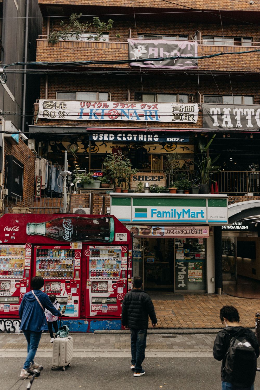 FamilyMart convenience store with vending machines outside in a Japanese neighborhood.
