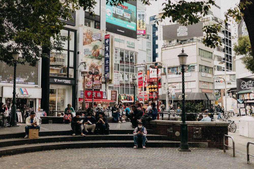 Urban plaza with electronic billboards and signage in a Japanese shopping district.