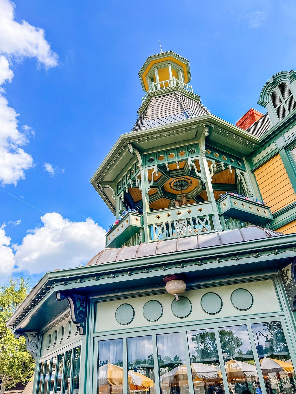 Victorian-style gazebo restaurant with turquoise trim and ornate architectural details set against a bright blue sky.