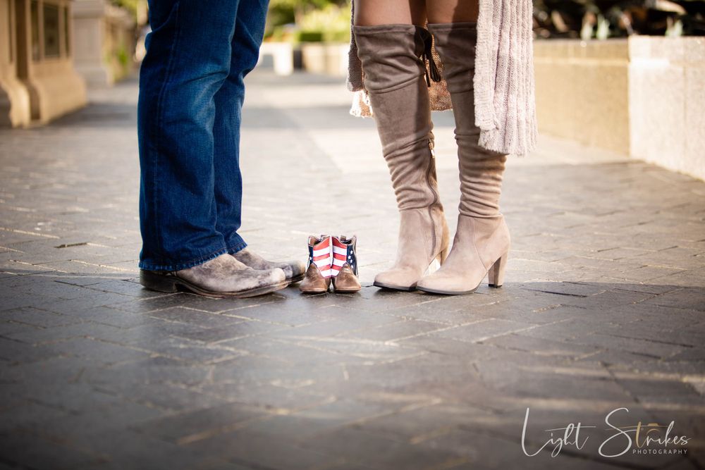 Maternity photo session and pair of baby shoes on a stone path walk.