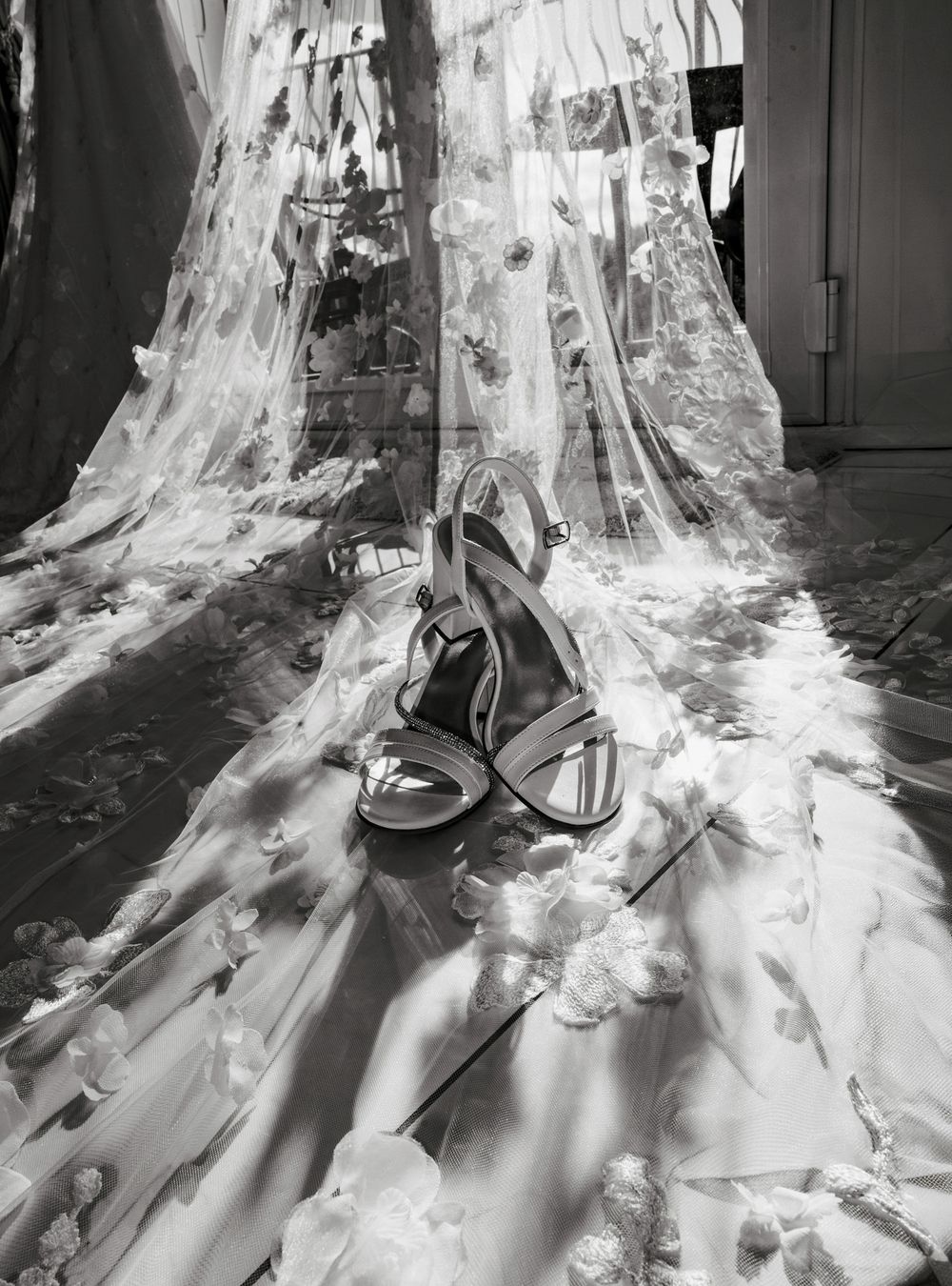 A series of black and white photographs showing the flowing movement of a long white wedding dress train.