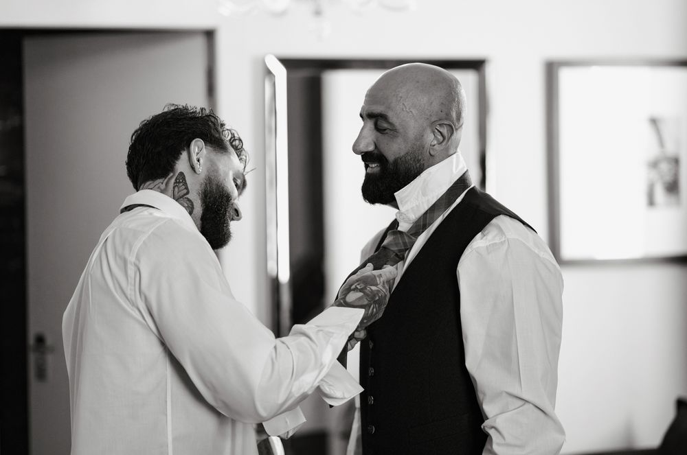 A sequence of black and white photos showing two people in formal attire having an intimate conversation.